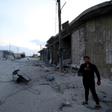 A man looks on at the site of a reported rocket attack by Syrian regime forces and their allies on the village of Kafr Nabl, south of the jihadist-held Syrian province of Idlib