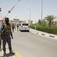 Iraqi soldiers guard the entrance of an oil fied in Basra, an oil-rich province where US companies including ExxonMobil and Baker Hughes are operational