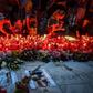 Protesters placed flowers and candles at a makeshift memorial outside the interior ministry in the capital Bucharest on Saturday evening