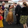 US Secretary of State Mike Pompeo and his wife Susan are greeted by women with traditional mwar mwar floral wreaths as they arrive at Pohnpei International Airport in Kolonia, Micronesia