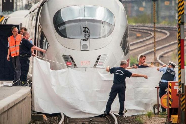 An Eritrean man has been charged with murder and attempted murder for pushing a mother and her son in front of a train as it arrived in Frankfurt
