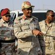 Mohamed Hamdan Dagalo (C), deputy head of Sudan's ruling Transitional Military Council (TMC) and commander of the Rapid Support Forces (RSF) paramilitaries, is escorted through the village of Qarri, north of Khartoum, on June 15, 2019