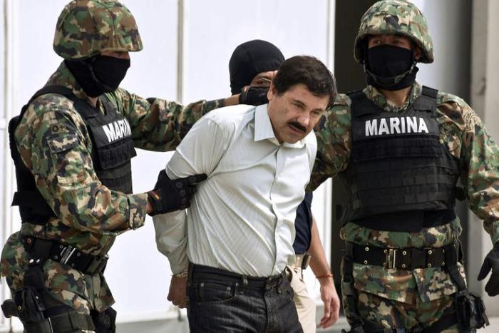 Joaquin "El Chapo" Guzman is escorted by marines as he is presented to reporters in Mexico City soon after his arrest in February 2014