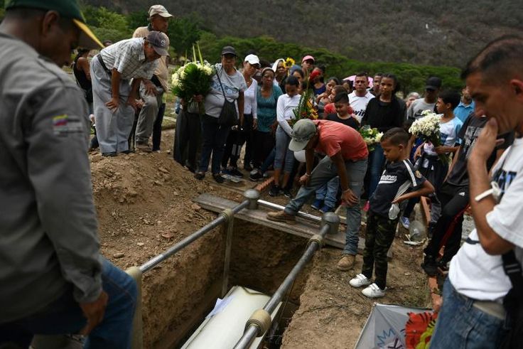 Relatives and friends of Erick Altuve attend his funeral
