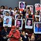 Relatives and friends of victims of the 2009 coup that ousted former president Manuel Zelaya hold portraits of their loved ones during a forum in Tegucigalpa on June 27, 2019