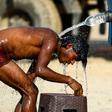 An Indian truck driver takes a cooling bath in Allahabad, where temperatures have neared 50 degrees Celsius (122 Fahrenheit)