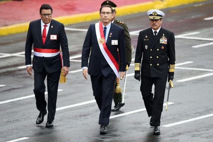 Peru's late defense minister Jose Huerta (L), seen walking next to President Martin Vizcarra (C) at a celebratory parade in Lima in July 2018, died of a heart attack suffered during a visit to troops