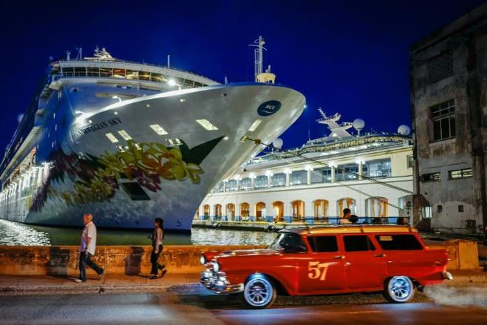 An old American car passes by the "Empress of the Seas", the last US-operated cruise ship to dock in Cuba following fresh US sanctions that ban stopovers on the island
