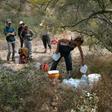 A volunteer for the humanitarian aid organization No More Deaths delivers water along a trail used by undocumented immigrants in the desert near Ajo, Arizona
