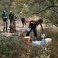 A volunteer for the humanitarian aid organization No More Deaths delivers water along a trail used by undocumented immigrants in the desert near Ajo, Arizona