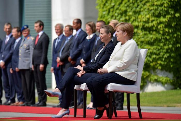 German Chancellor Angela Merkel and Denmark's Prime Minister Mette Frederiksen sat as they listened to the national anthems