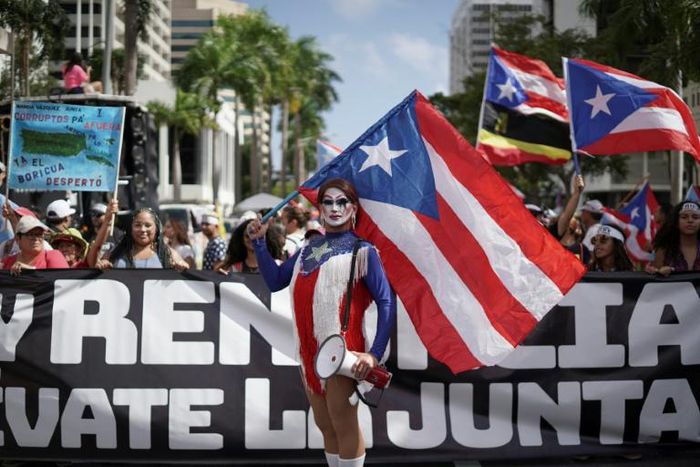 People march in San Juan, Puerto Rico on July 25, 2019, one day after the resignation of Governor Ricardo Rossello