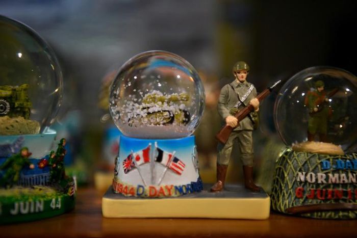 Snow globes commemorating the June 1944 Normandy landings at a souvenir shop in Saint-Côme-du-Mont, France