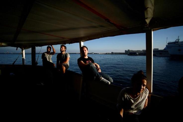 "It would be desirable if... an agreement is reached so that seven or eight countries coordinate to distribute the people," said Proactiva Open Arms founder Oscar Camps. Crew members are shown aboard the ship on World Refugee Day in June