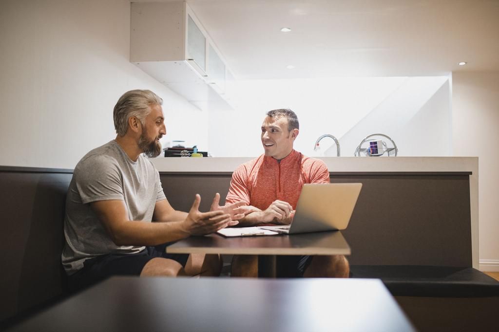 Personal Trainer and Client Meeting Before a Training Session