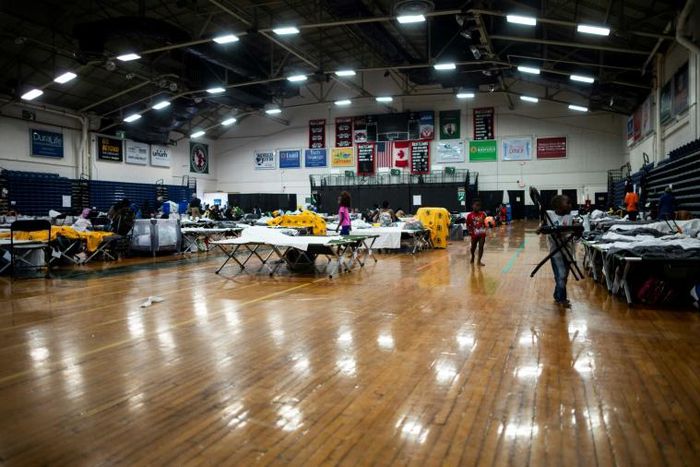 Cots are set up for migrants in The Expo, a sports complex converted into an emergency shelter, in Portland, Maine -- hundreds of Africans have turned the city into an unlikely sanctuary