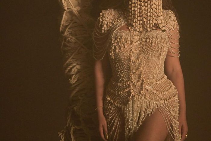 Beyonce has been heavily influenced by African culture especially Yoruba culture as of late. Here she is wearing a face mask made from cowries (Pink Now)