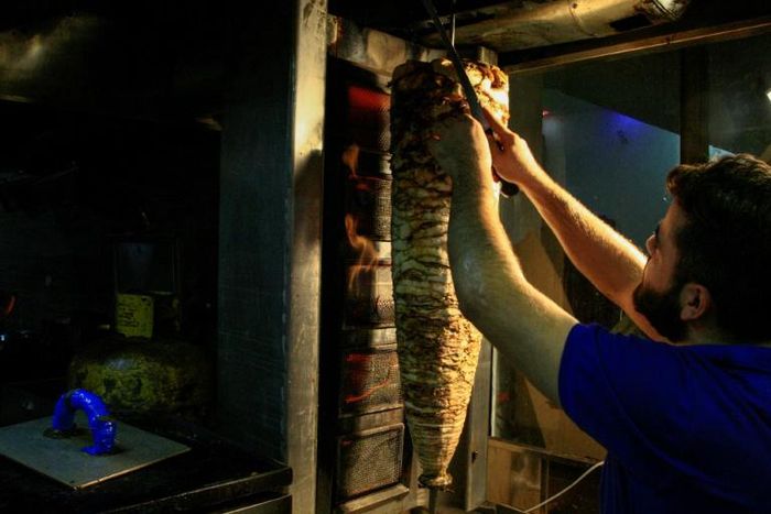 The tantalising odours of popular Syrian dishes of shawarma, fatteh and garlic sauce fill the air of the Kafouri district in Sudan's capital Khartoum