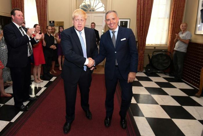 Cummings is pictured in jeans and a T-shirt, in the corner on the right, as Johnson entered Downing Street last week, shown shaking hands with Cabinet Secretary Mark Spencer