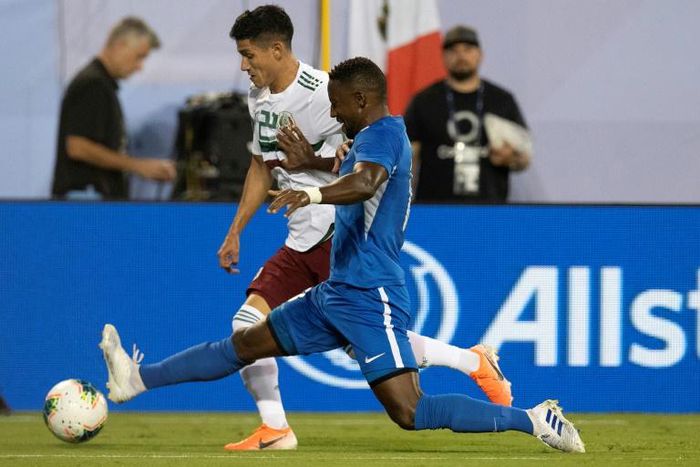 Mexico's Uriel Antuna (L) vies for the ball with Martinique's Samuel Camille (R) during their CONCACAF Gold Cup Group A match in Charlotte, North Carolina
