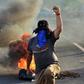 Honduran colleges students block a road in the capital Tegucigalpa during a protest against the government of President Juan Orlando Hernandez