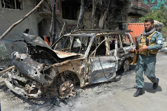 A member of the Afghan security forces walks past the site of an attack in Kabul this week