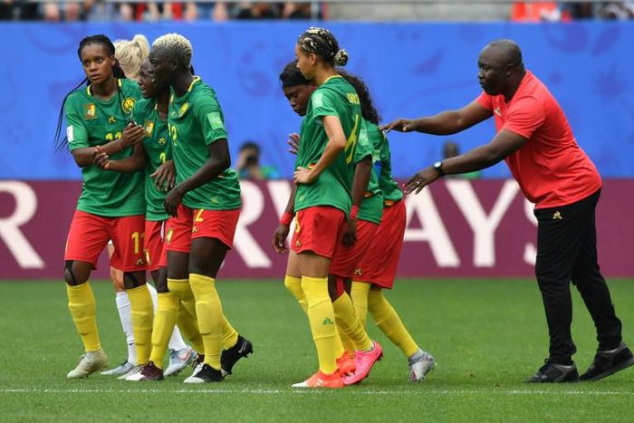 Cameroon coach Alain Djeumfa (R) said his players remained 'very professional' throughout their bad-tempered 3-0 defeat against England on Sunday
