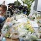 People continued to pay tribute to the victims on Saturday, leaving flowers