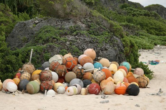 A pile of collected fishing bouys on a beach on Henderson Island, an uninhabited part of the Pitcairn archipelago in the South Pacific Ocean