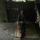 A Yukpa woman suffering from fever due to malaria sits on the floor of her house on June 11, 2019
