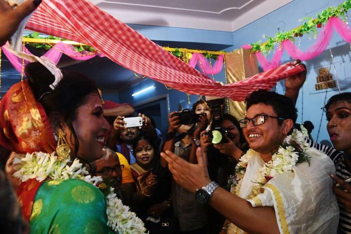 Indian transgender woman Tista Das (L), 38, and transgender man Dipan Chakravarthy, 40, perform the rituals of a traditional Hindu marriage ceremony, pledging their love for each other before family and friends, in Kolkata