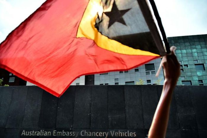 An East Timorese student waves his national flag during a 2016 protest about Australia's intentions in the Timor Sea