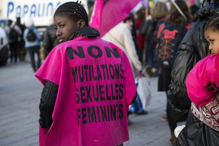 A woman wears a jersey reading, "No to female genital mutilation" during a demonstration in 2018