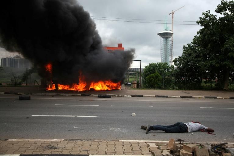 A member the shiite Islamic Movement of Nigeria (IMN) lies on the ground after being shot dead during clashes between IMN and the police in the streets of Abuja on July 22, 2019. The Shiites are protesting against the detention of IMN leader Ibrahim Za...