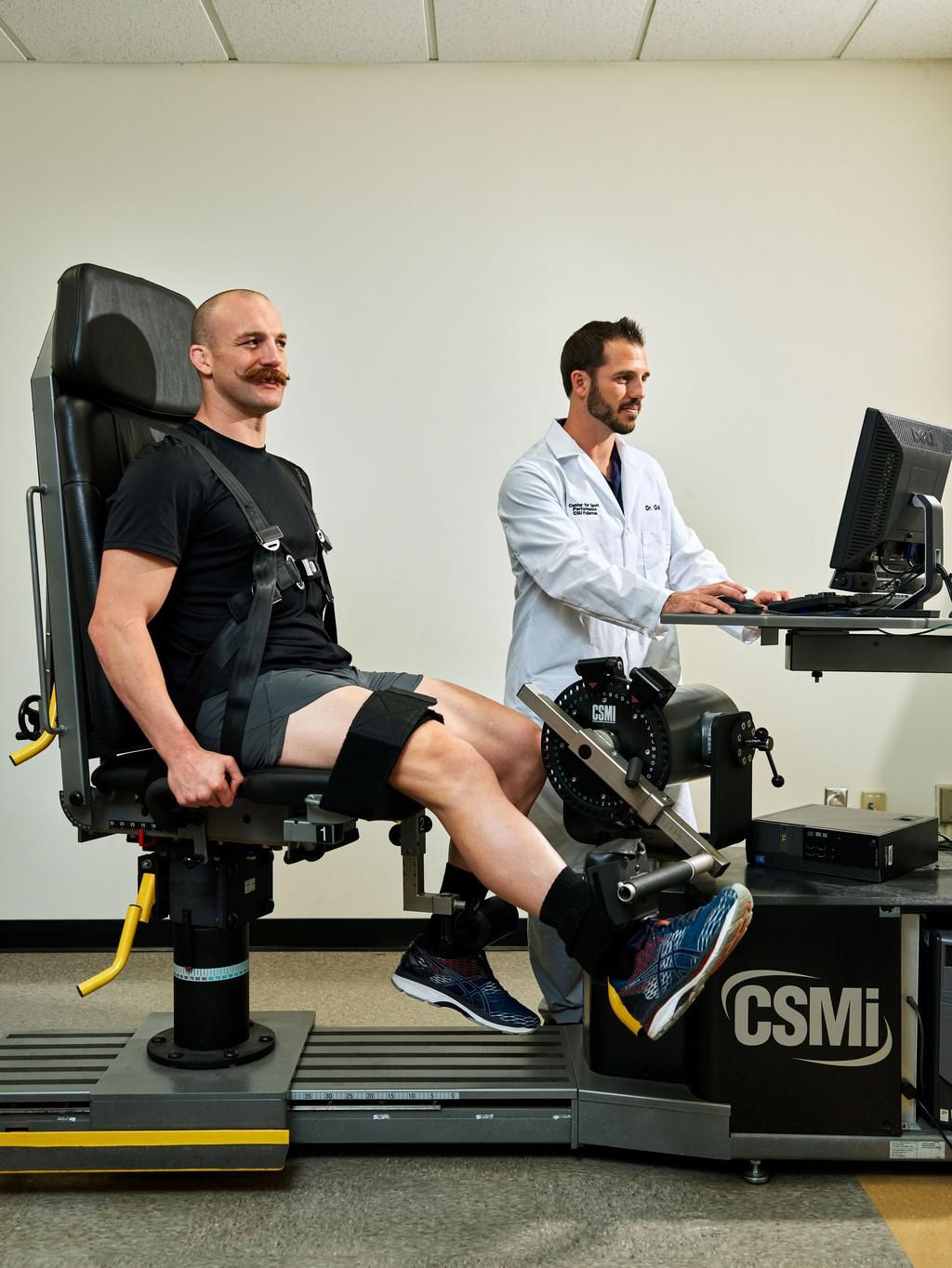 Andy Galpin tests the leg strengthof UFC star Patrick Cummins. Leg extension tests may indicate mortality risk.
