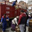 A man downloads gas cylinders from a truck in La Paz as life gets back to normal after weeks of protests