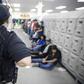 A Homeland Security officer guards some of the 680 suspected undocumented migrants detained in Mississippi after Immigration and Customs Enforcement officers raided several slaughterhouses