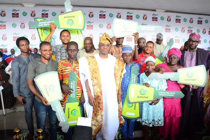 Winners of the ten tricycles displaying their dummy keys with Globacom Representative, Mr. Folu Aderibigbe (right) and the Ogun State Governor, Prince Dapo Abiodun (middle) moments after receiving the keys of the tricycles at the grand finale of the 2...