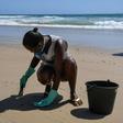 Council workers scrape spilled crude off the beach in Itapuama in northeastern Brazil as the country rushes to prepare for the peak tourism season