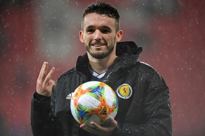 Scotland midfielder John McGinn poses with the match ball after scoring three against San Marino