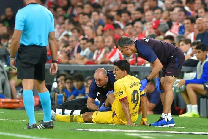 Doctors attend Barcelona forward Luis Suarez on Friday