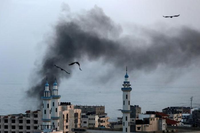 Smoke rises over Gaza City as Israel carries out a second day of air and missile strikes in response to barrages of rocket fire following its targeted killing of a top militant