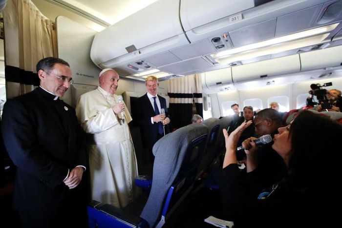 Pope Francis (2ndL) is flanked by his spokesperson Matteo Bruni (3rdL) and the Pope's trip organizer Father Mauricio Rueda, during his flight from Antamanarivo to Rome, on September 10, 2019, after his seven-day pastoral trip to countries in Africa