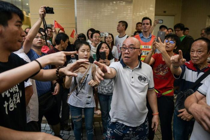 A group of men, many waving Chinese flags, attacked people perceived to be pro-democracy protesters