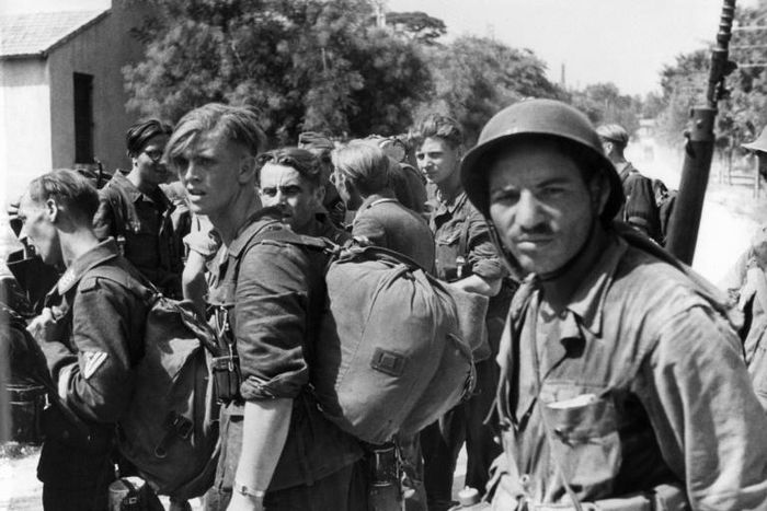 Algerian riflemen guarding German prisoners in Marseille, southern France, in August 1944