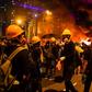Thick, black smoke swirled from a large fire started by masked Hong Kong protesters at a barricade on a major thoroughfare