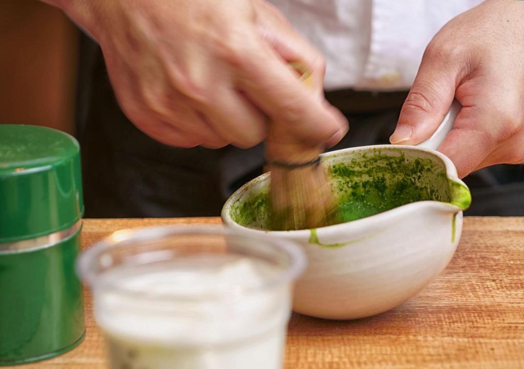 Close up of the traditional way of preparing green tea for macha latte, Japanese tea ceremony, Osaka.