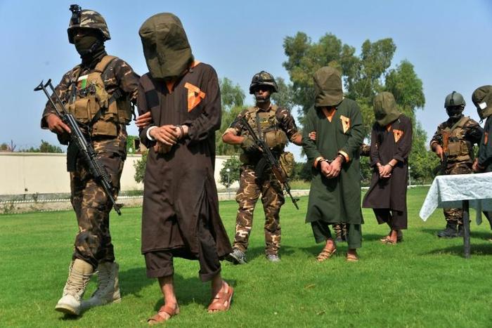 Afghan security personnel escort alleged Islamic State militants during an operation in Jalalabad province in October 2019. Officials say the IS Afghan branch has been defeated in one of the eastern provinces