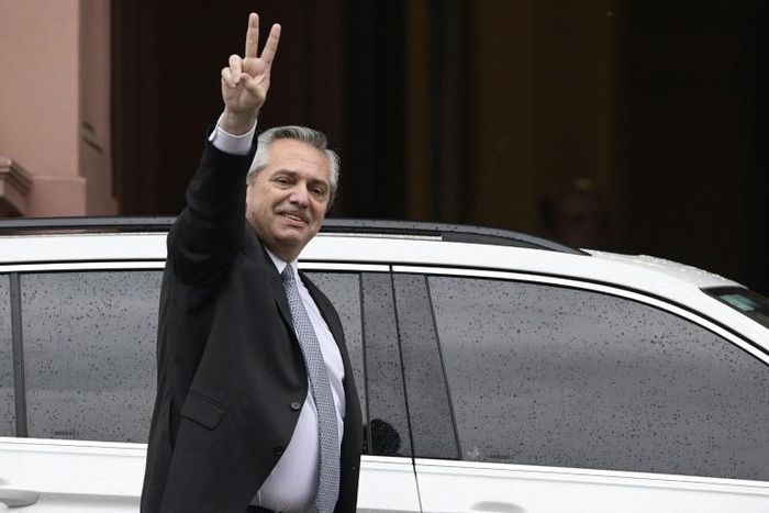 Argentina's president-elect Alberto Fernandez flashes de "V" sign as he leaves the Casa Rosada presidential palace after a meeting with President Mauricio Macri