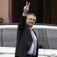 Argentina's president-elect Alberto Fernandez flashes de "V" sign as he leaves the Casa Rosada presidential palace after a meeting with President Mauricio Macri